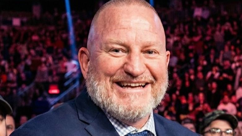 Road Dogg (Brian James) gives a quick smile towards the camera while in the crowd at a WWE event