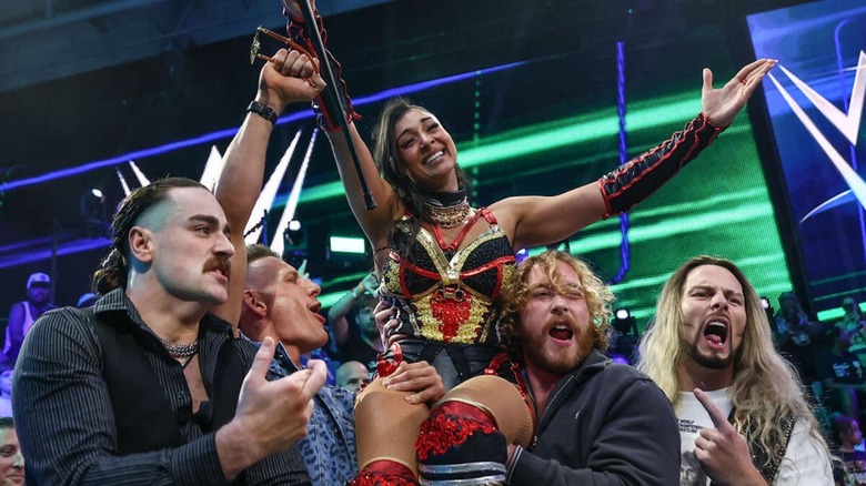 Arianna Grace is held up by her BirthRight stablemates after winning a WWE Women's Speed tournament match on 