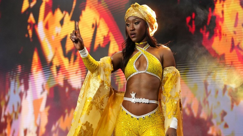 Queen Aminata poses on the stage before heading down the ramp to the ring on an episode of 