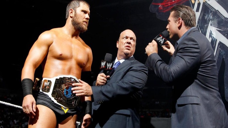 Paul Heyman holds back then-Intercontinental Champion Curtis Axel during a segment with The Miz on an episode of WWE TV.
