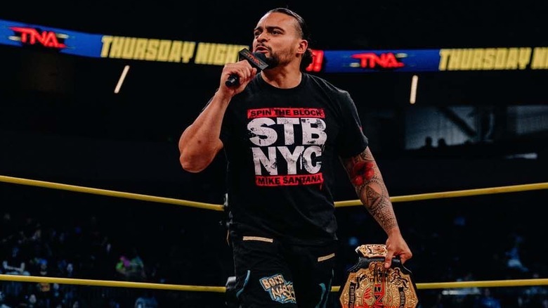 Mike Santana talking into a mic in a TNA ring
