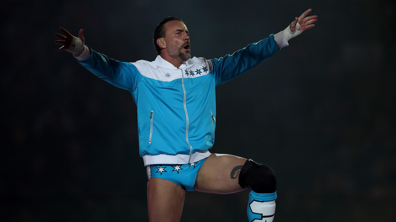 CM Punk stands on the top rope and looks out into the crowd before his scheduled match