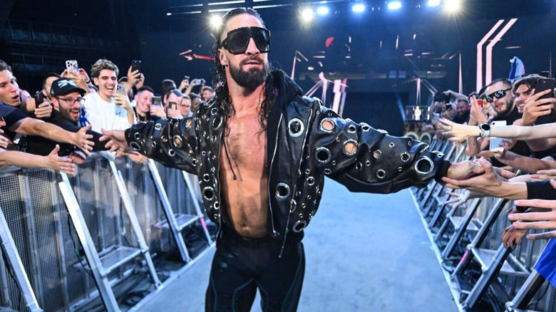 Seth Rollins high fives fans as he makes his way down to the ring for a King of the Ring tournament match on 
