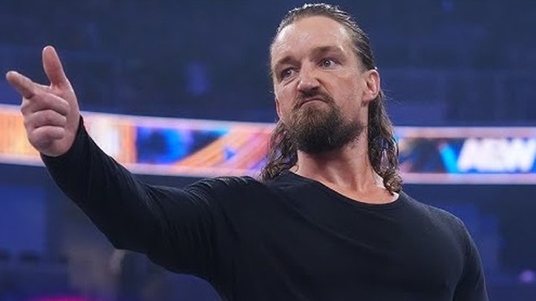 Jay White gives a finger gun pose behind David Finlay after his long-awaited return at this year's Forbidden Door