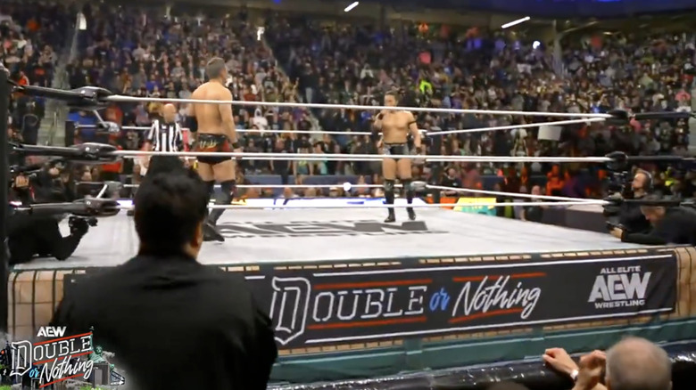 Okada and Takeshita staring down one another in the ring
