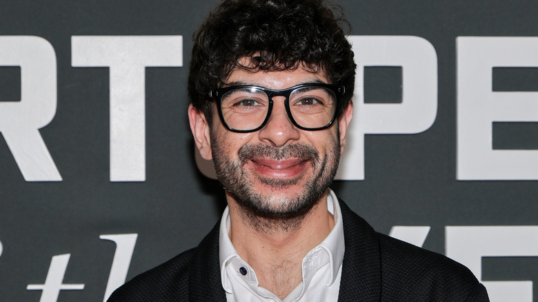 Tony Khan wearing glasses