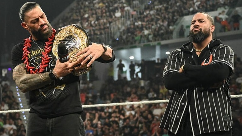 Jimmy Uso flanking Roman Reigns