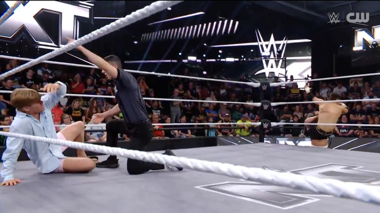 Baylor distracting the referee as Lockwood takes out Wilder on the outside