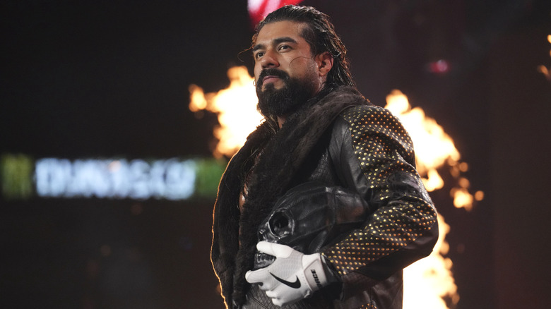 Andrade, mask in hand, heads down the ramp to the ring for a match at AEW Dynasty 2026.