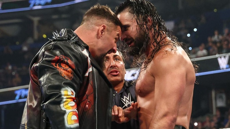 Bon Breakker and Seth Rollins go face-to-face, a referee positioned behind them, ahead of their match at WWE Backlash 2026.