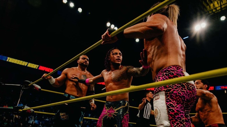 KC Navarro tries to break up a close call fight between TNA World Champion Mike Santana and Nic Nemeth