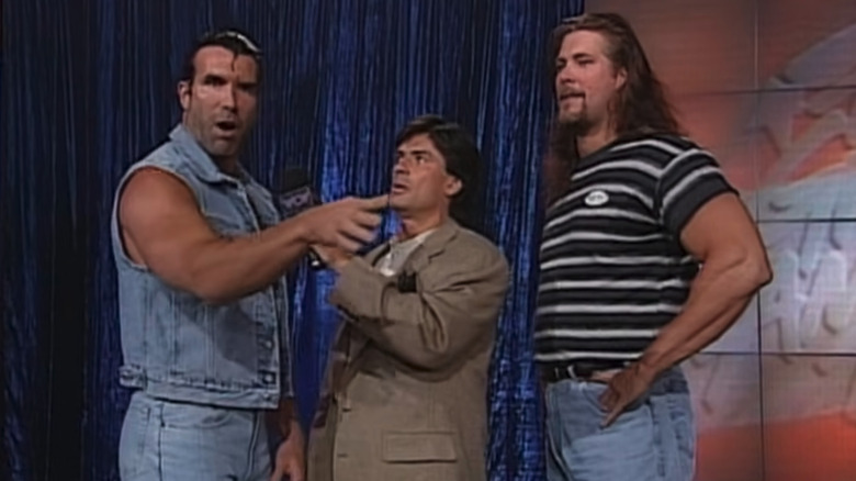 Scott Hall and Kevin Nash standing at either side of Eric Bischoff at WCW Great American Bash 1996
