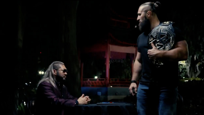 Naraku sitting as D'Angelo stands up