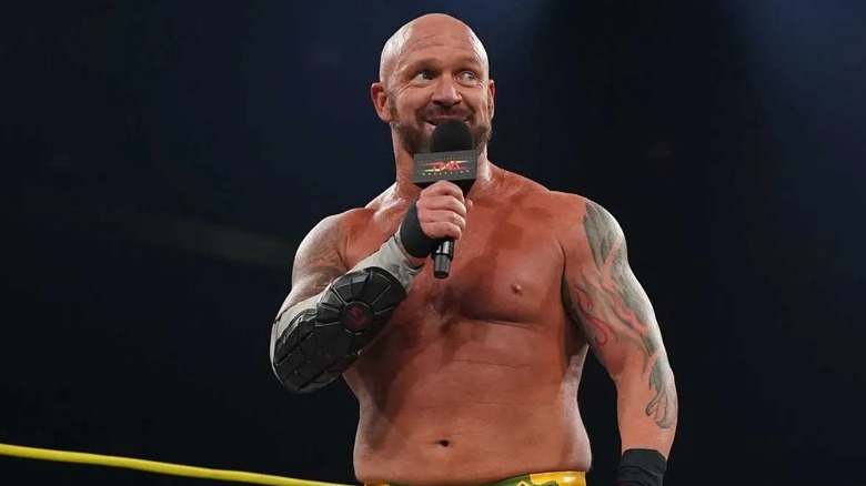 Eric Young speaking into a TNA mic