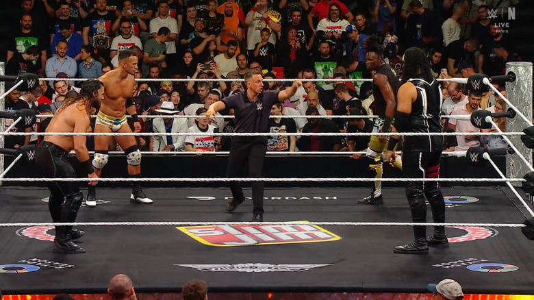 All four men staring down one another in the ring