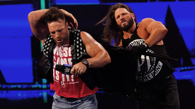 AJ Styles attacks LA Knight with a chair