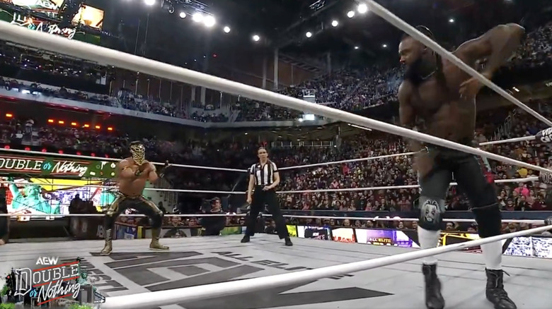 Bandido and Strickland both staring down one another in the ring