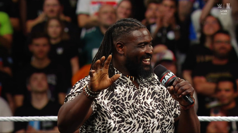 Femi smiling and talking in the ring
